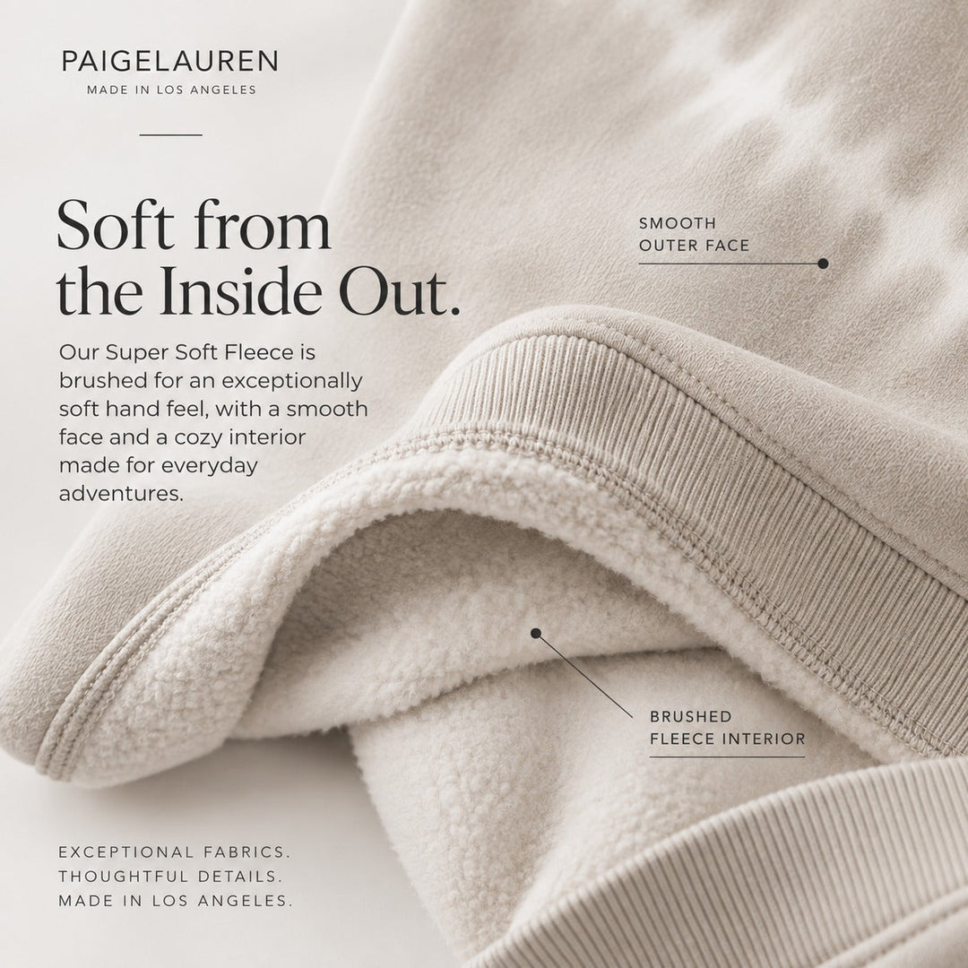Toddler wearing the PAIGELAUREN Bone Super Soft Fleece sweatshirt and sweatpant set with subtle hand-dyed white detailing, part of the brand's small-batch children's clothing made in Los Angeles.