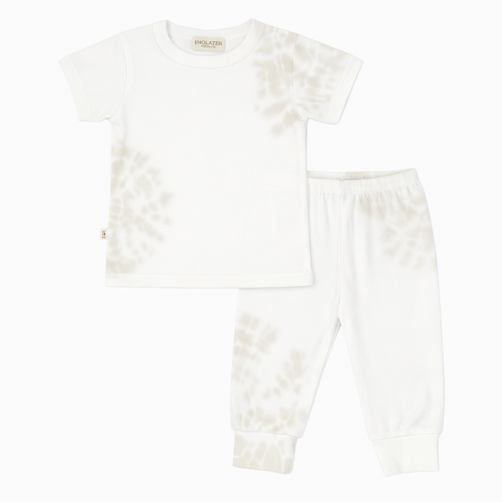 White pajama set with ruffled sleeves on a white background