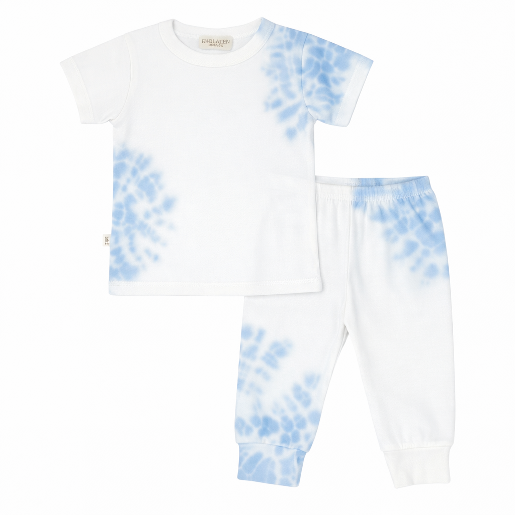 White t-shirt and pants with blue tie-dye pattern on a white background