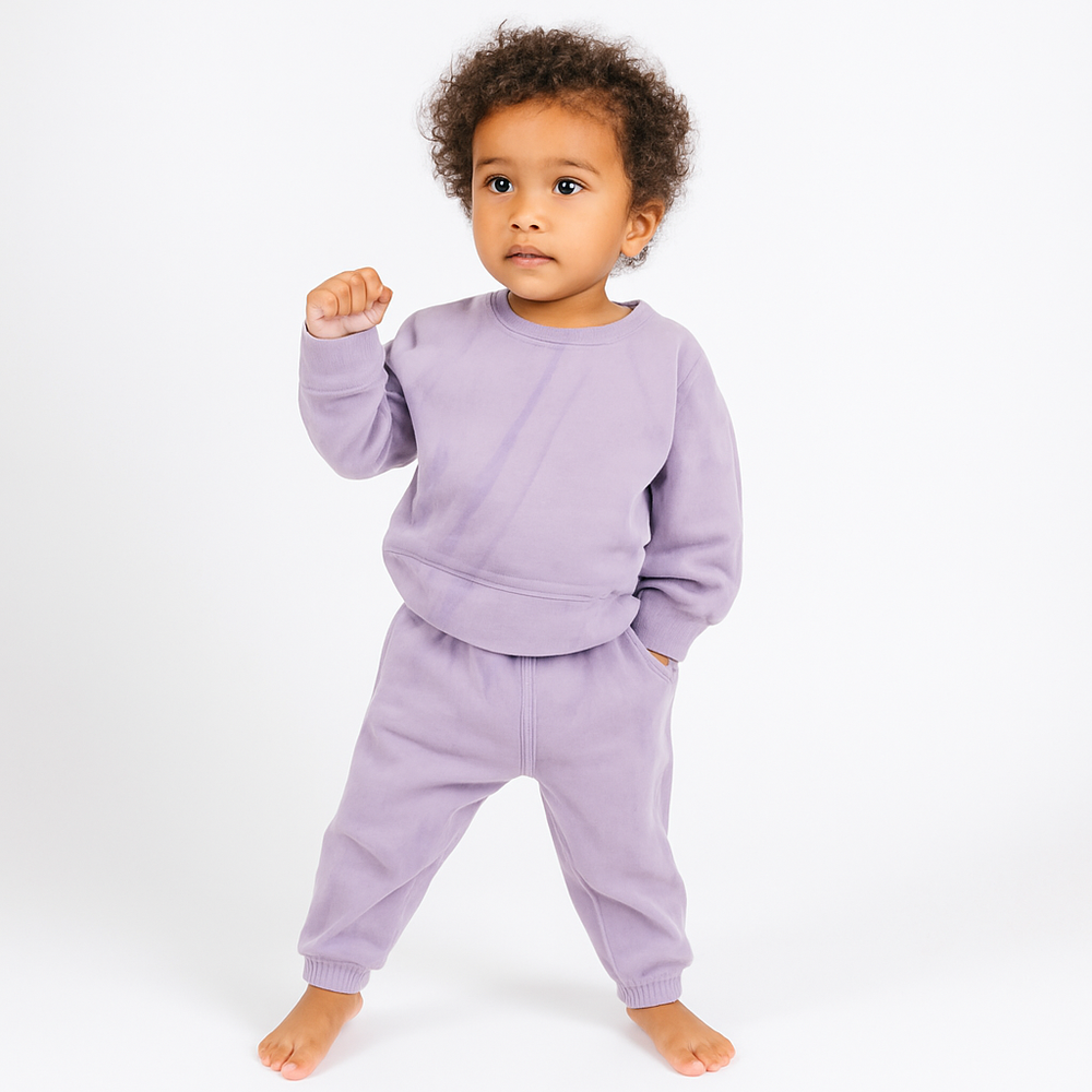 Child wearing a purple outfit on a white background