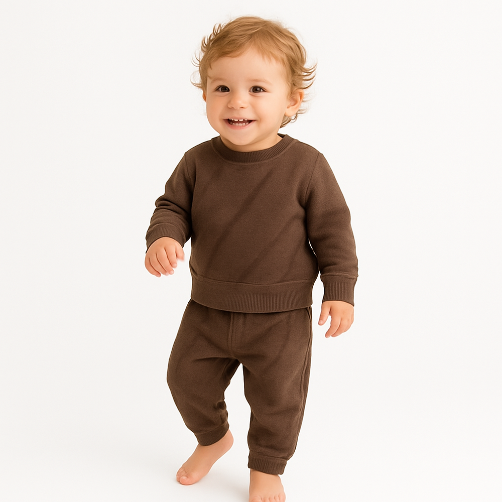 Child wearing a brown outfit on a white background