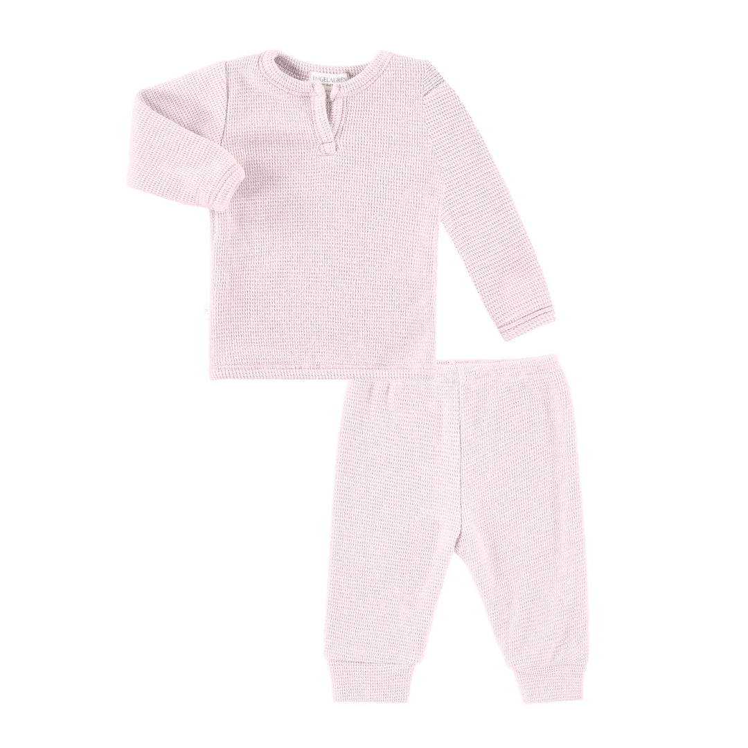 Pink baby outfit with long-sleeve top and pants on a white background