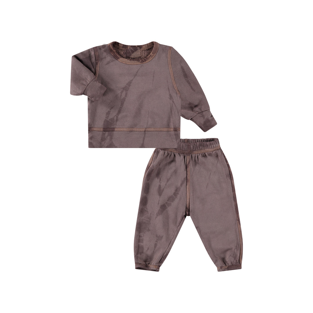 A tie-dye loungewear set for toddlers, featuring a hoodie and pants in shades of grey and brown, made from organic cotton and other materials.