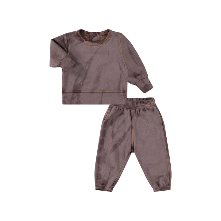 A tie-dye loungewear set for toddlers, featuring a hoodie and pants in shades of grey and brown, made from organic cotton and other materials.