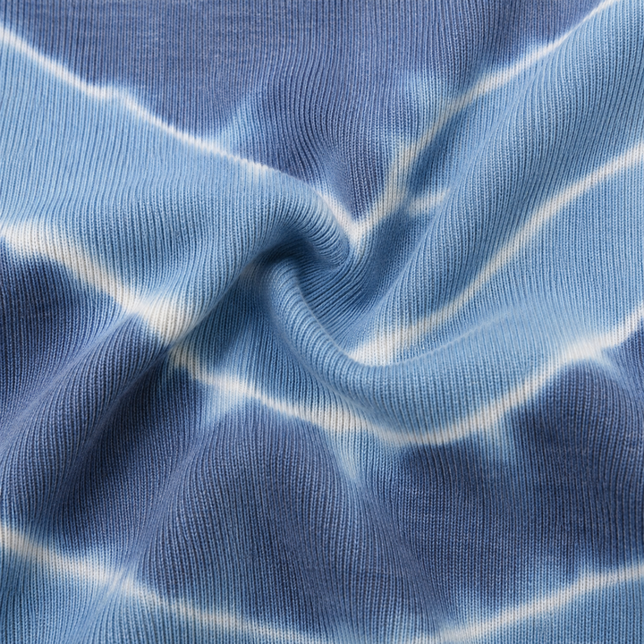 Close-up of the ultra-soft hand-dyed baby rib cotton fabric in blue tie dye by PAIGELAUREN