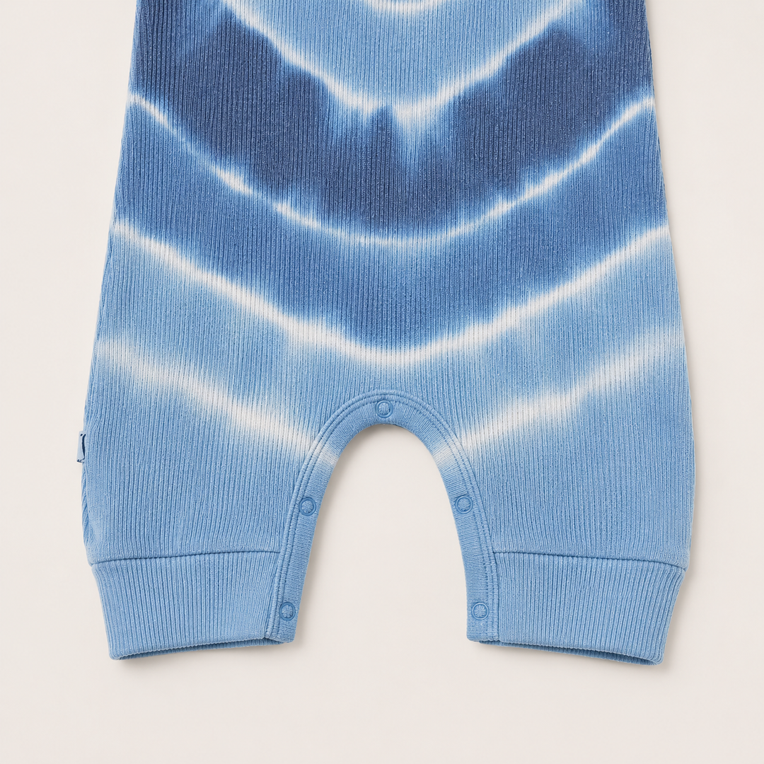 Close-up of the color-matched ring snap inseam and baby rib fabric on the PAIGELAUREN Blue Tie Dye Tank Overall