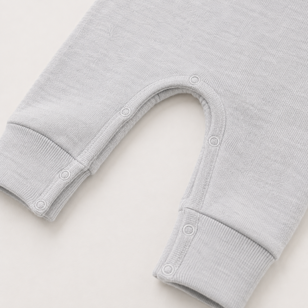 Close-up of the snap inseam and contrast stitching on the PAIGELAUREN Fleece Sweatshirt Henley Romper