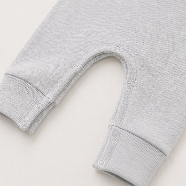 Close-up of the snap inseam and contrast stitching on the PAIGELAUREN Fleece Sweatshirt Henley Romper