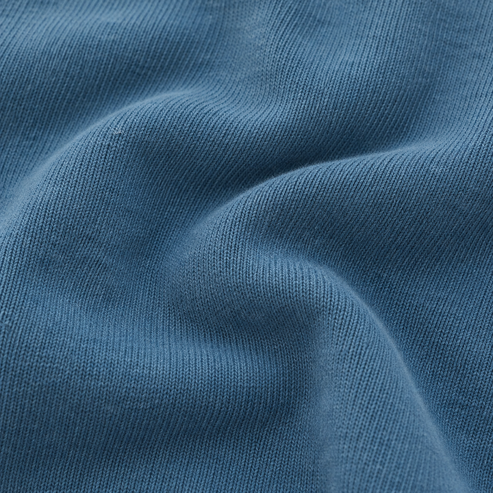 Close-up of the ultra-soft brushed fleece fabric on the PAIGELAUREN Fleece Sweatshirt Henley Romper