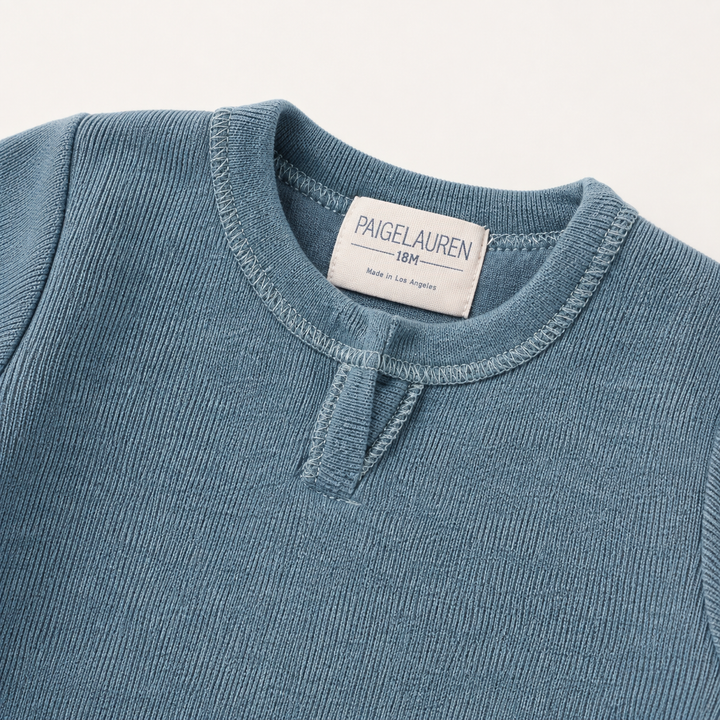 Close-up of the Henley neckline and rib trim on the PAIGELAUREN Fleece Sweatshirt Henley Romper