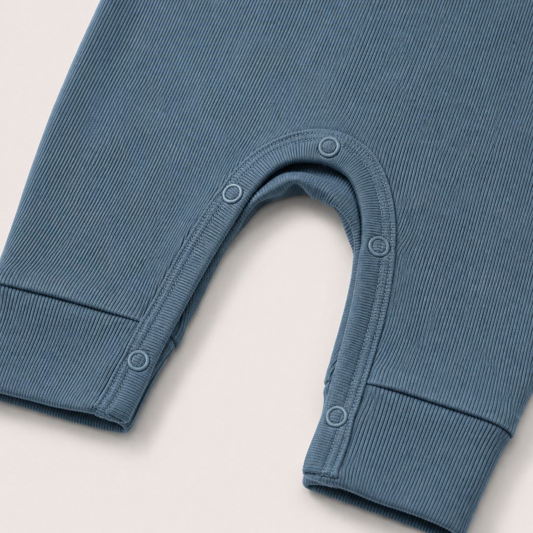 Close-up of the snap inseam and contrast stitching on the PAIGELAUREN Fleece Sweatshirt Henley Romper