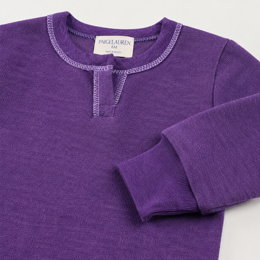 Close-up of the sleeve, rib cuff, and Henley neckline on the PAIGELAUREN Fleece Sweatshirt Henley Romper