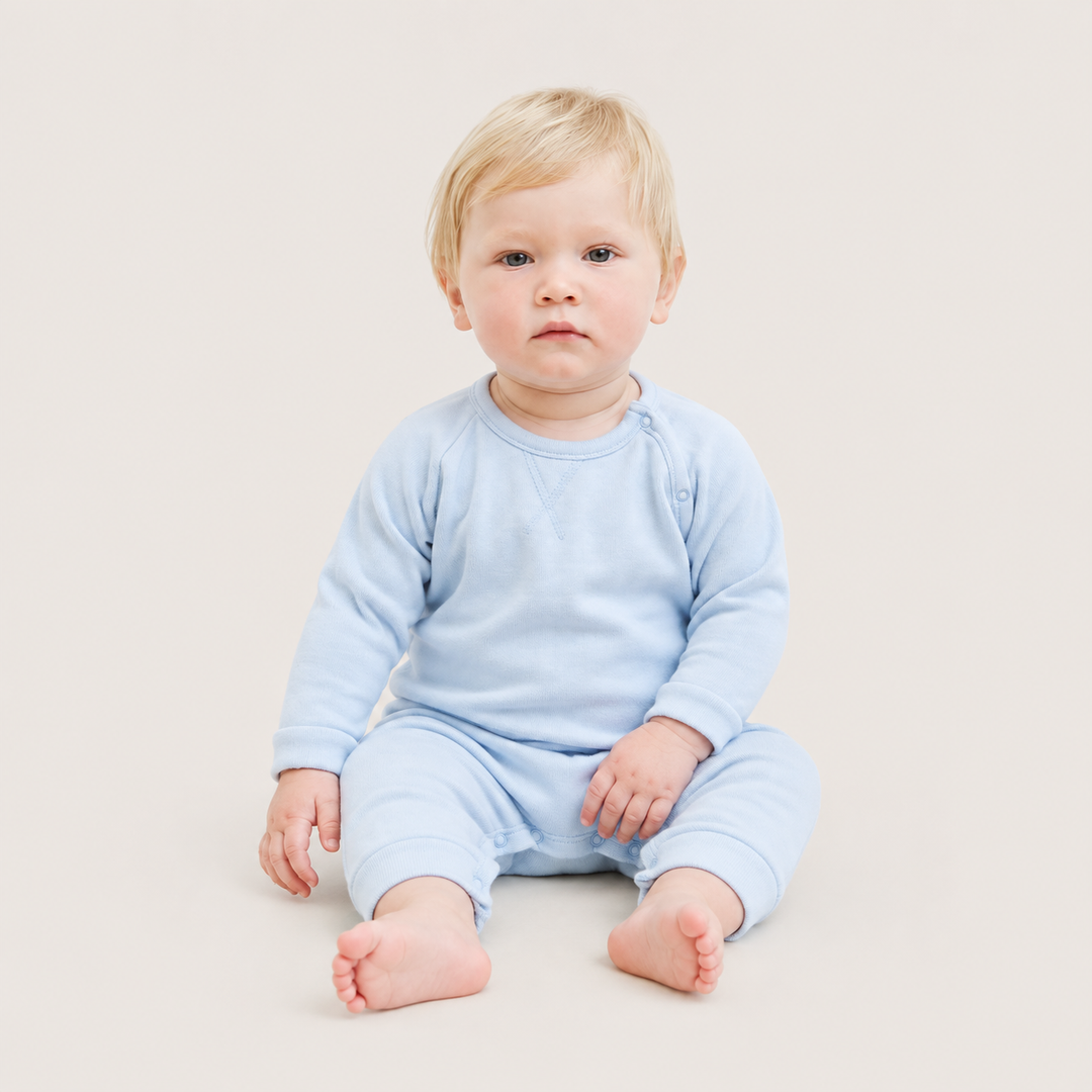 Baby wearing the PAIGELAUREN Fleece Sweatshirt Raglan Romper in Light Blue while sitting