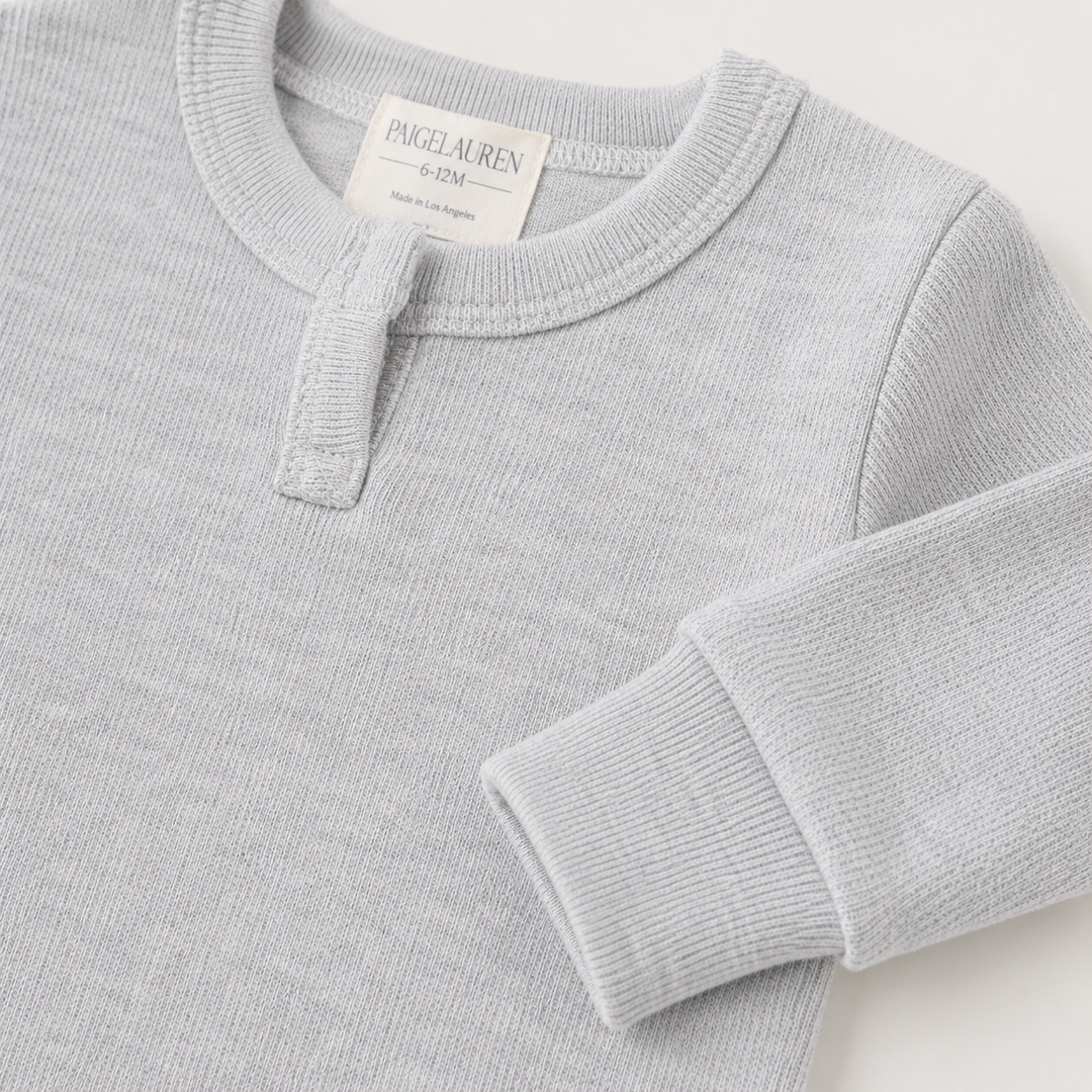 Close-up of the sleeve, rib cuff, and Henley neckline on the PAIGELAUREN Fleece Sweatshirt Henley Romper