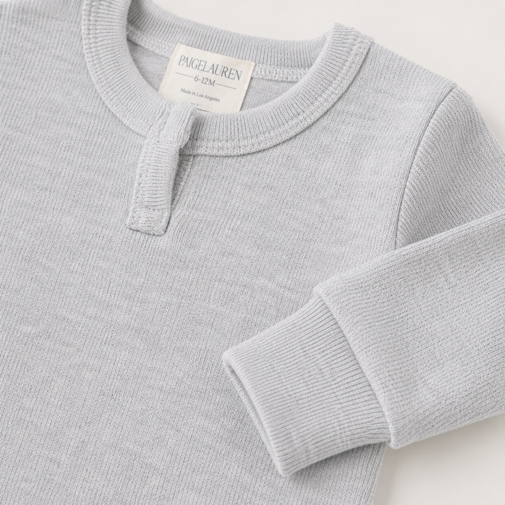 Close-up of the sleeve, rib cuff, and Henley neckline on the PAIGELAUREN Fleece Sweatshirt Henley Romper