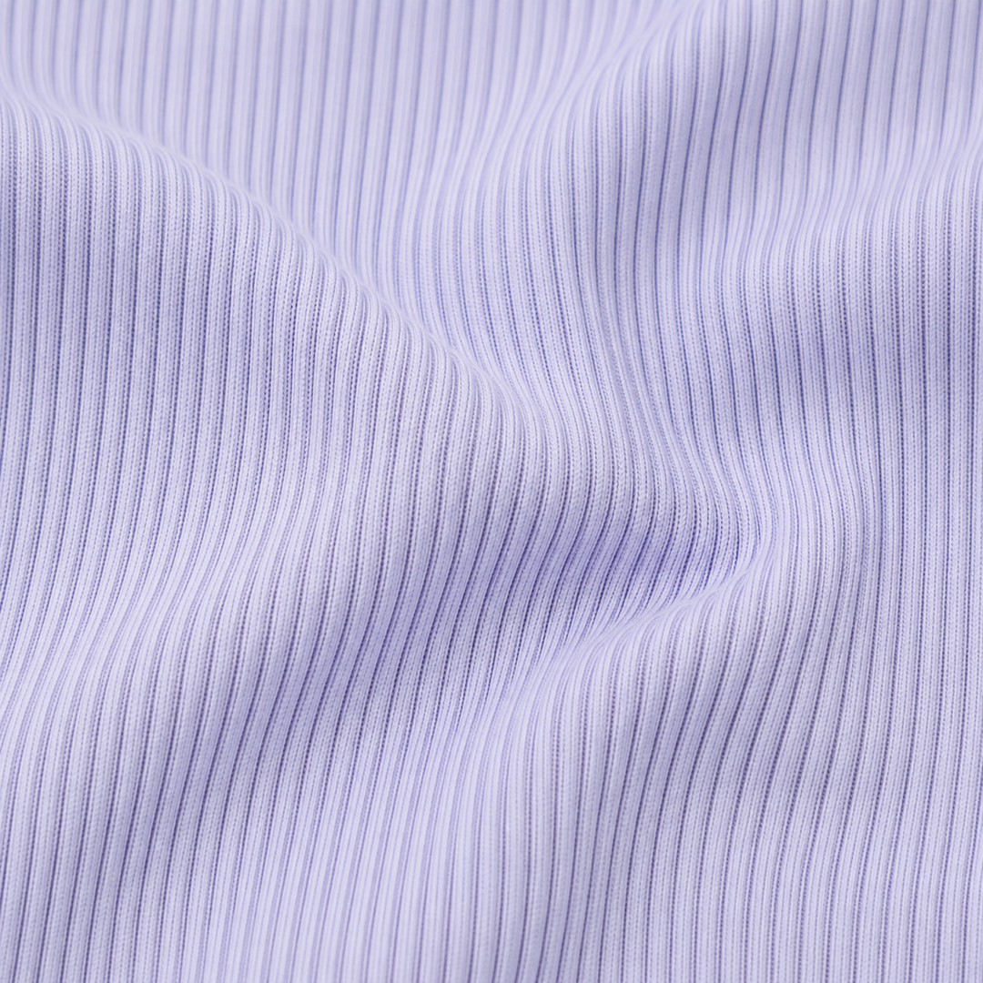 Close-up of the premium garment-dyed 2x1 rib cotton fabric used on the PAIGELAUREN Shortall Onesie. Lavender