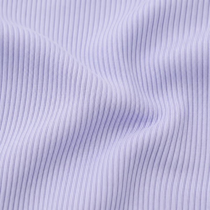 Close-up of the premium garment-dyed 2x1 rib cotton fabric used on the PAIGELAUREN Shortall Onesie. Lavender
