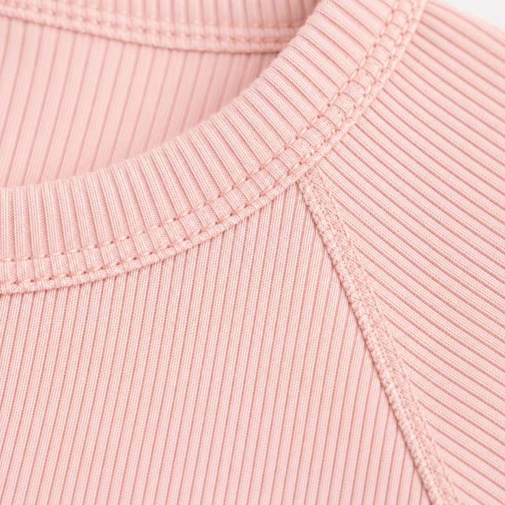 Close-up of the premium topstitching and ribbed neckline on the PAIGELAUREN Garment Dye Ribbed Shortall Onesie