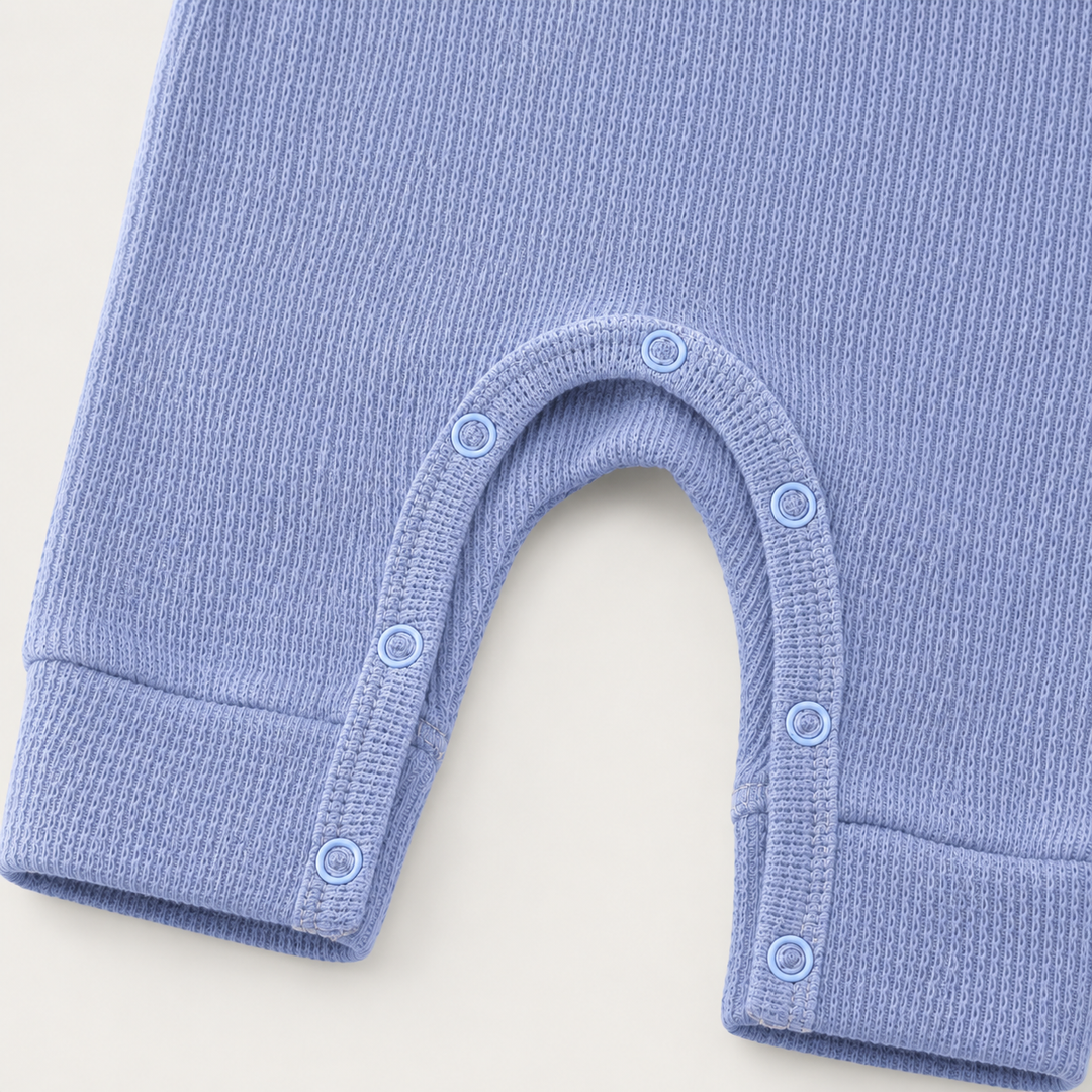 Close-up of matching snap closure and thermal knit on the PAIGELAUREN Garment Dyed Thermal Romper