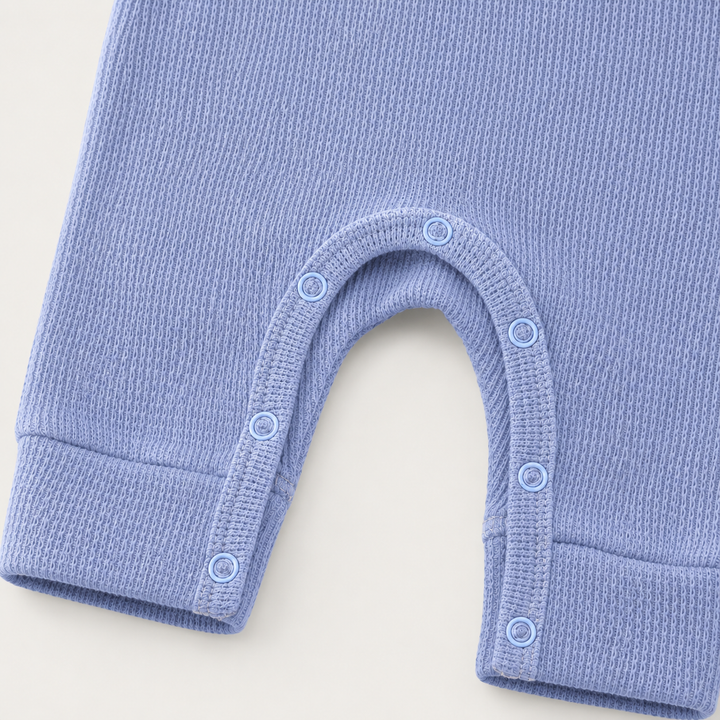 Close-up of matching snap closure and thermal knit on the PAIGELAUREN Garment Dyed Thermal Romper