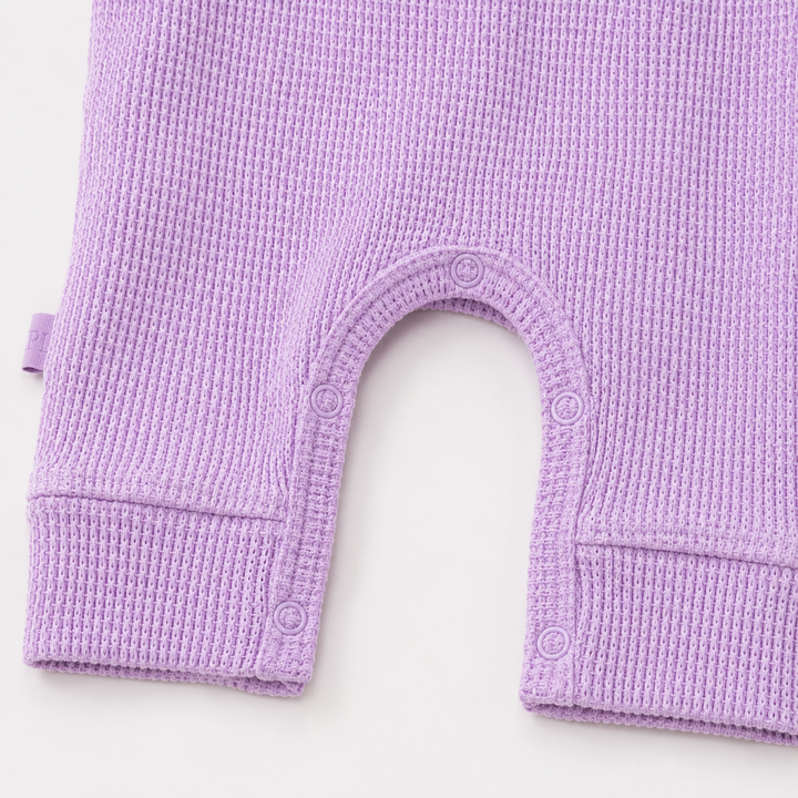 Close-up of matching snap closure and thermal knit on the PAIGELAUREN Garment Dyed Thermal Romper. Lilac