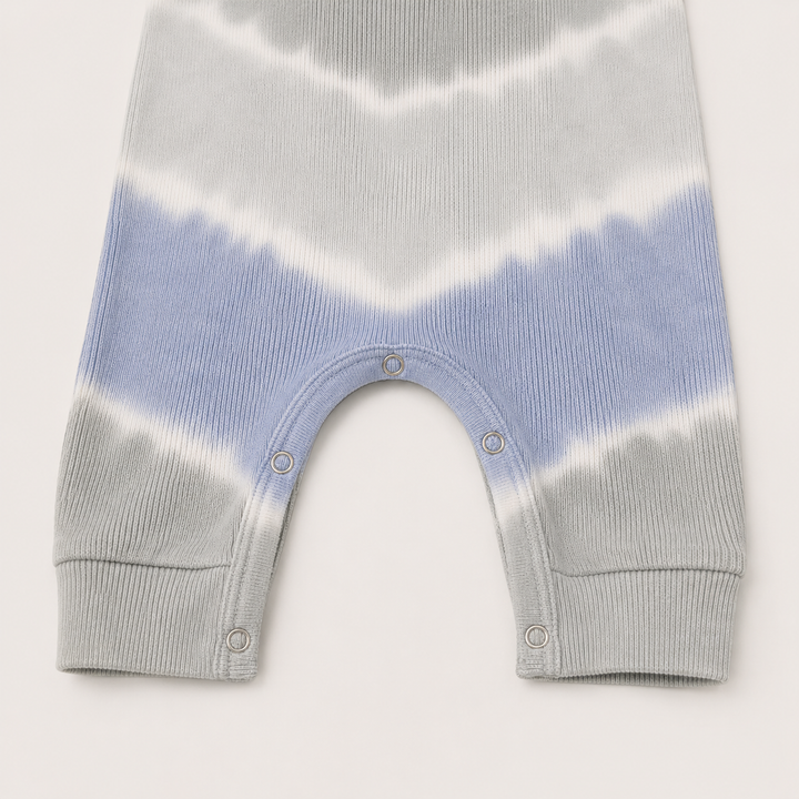 Close-up of the color-matched ring snap inseam and reinforced stitching on the PAIGELAUREN Gray Baby Rib Tie Dye Tank Overall