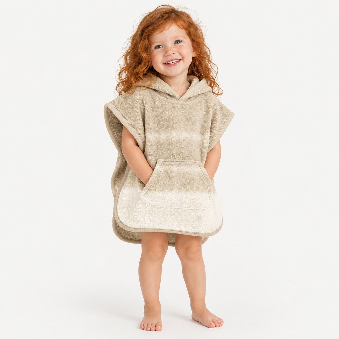 Red-haired toddler girl wearing PAIGELAUREN Beige Ombré Loop Terry Hooded Poncho