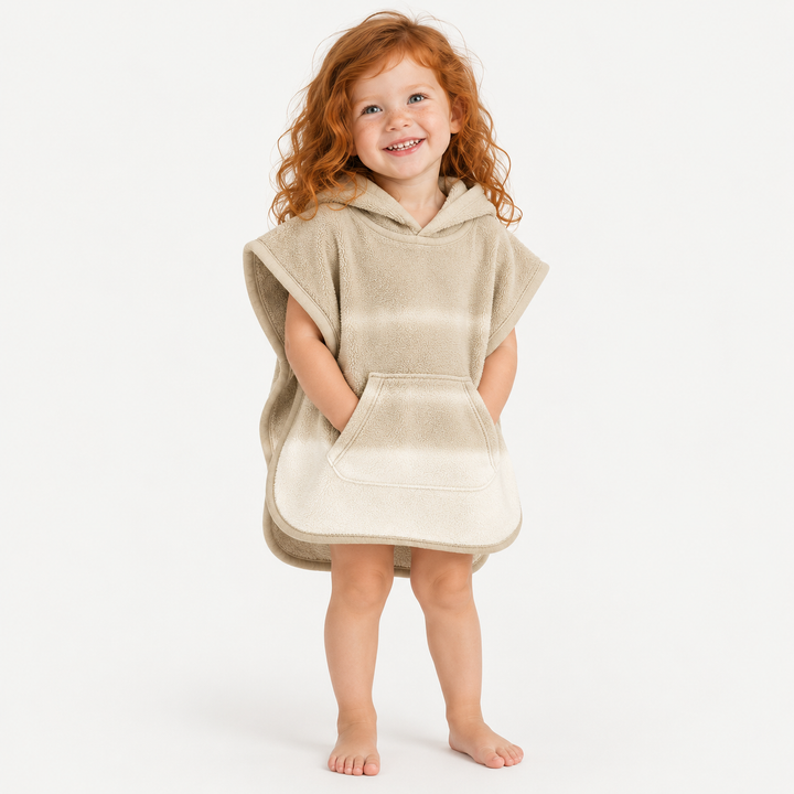 Red-haired toddler girl wearing PAIGELAUREN Beige Ombré Loop Terry Hooded Poncho