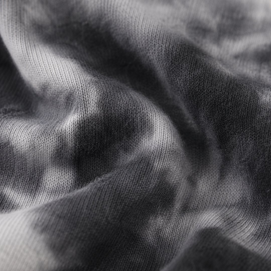 Close-up of soft fuzzy Black Brushed Hacci Tie Dye fabric