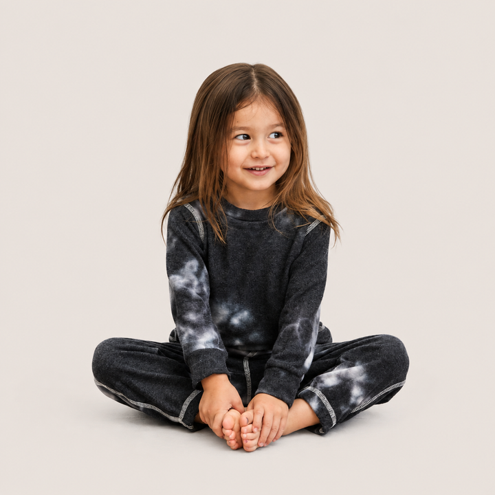 Toddler wearing PAIGELAUREN Black Brushed Hacci Tie Dye Pullover and Pant Set
