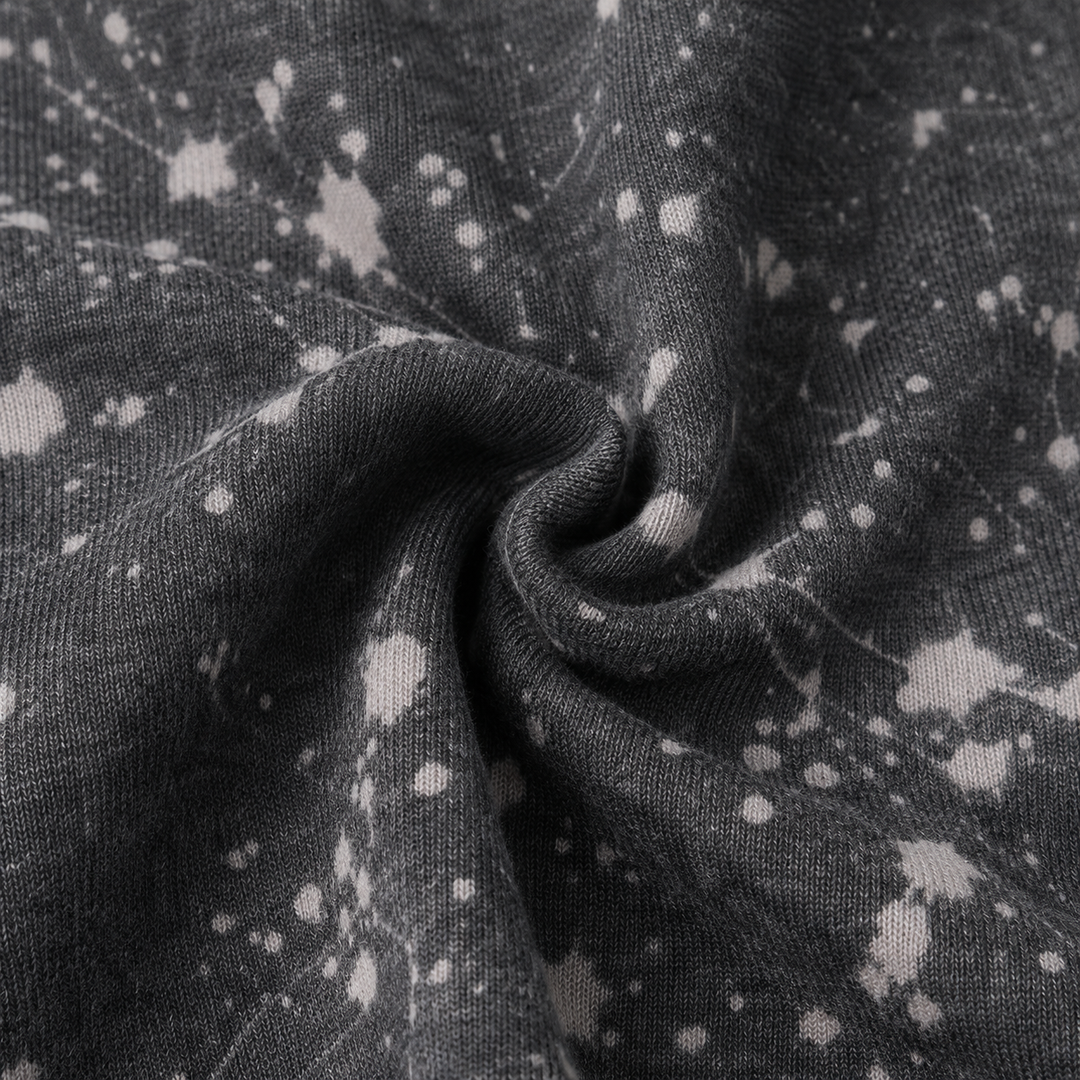 Close-up of PAIGELAUREN Black Splatter Brushed Rib fabric