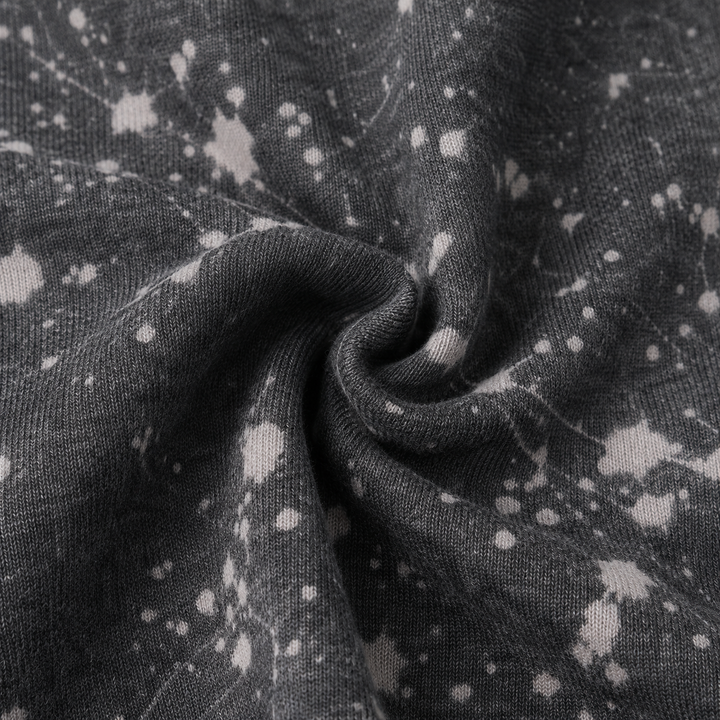 Close-up of PAIGELAUREN Black Splatter Brushed Rib fabric