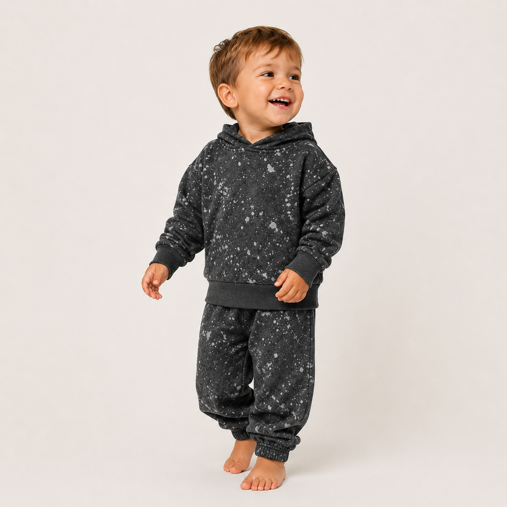 Toddler wearing PAIGELAUREN Black Splatter Brushed Rib Hoodie and Balloon Pant Set