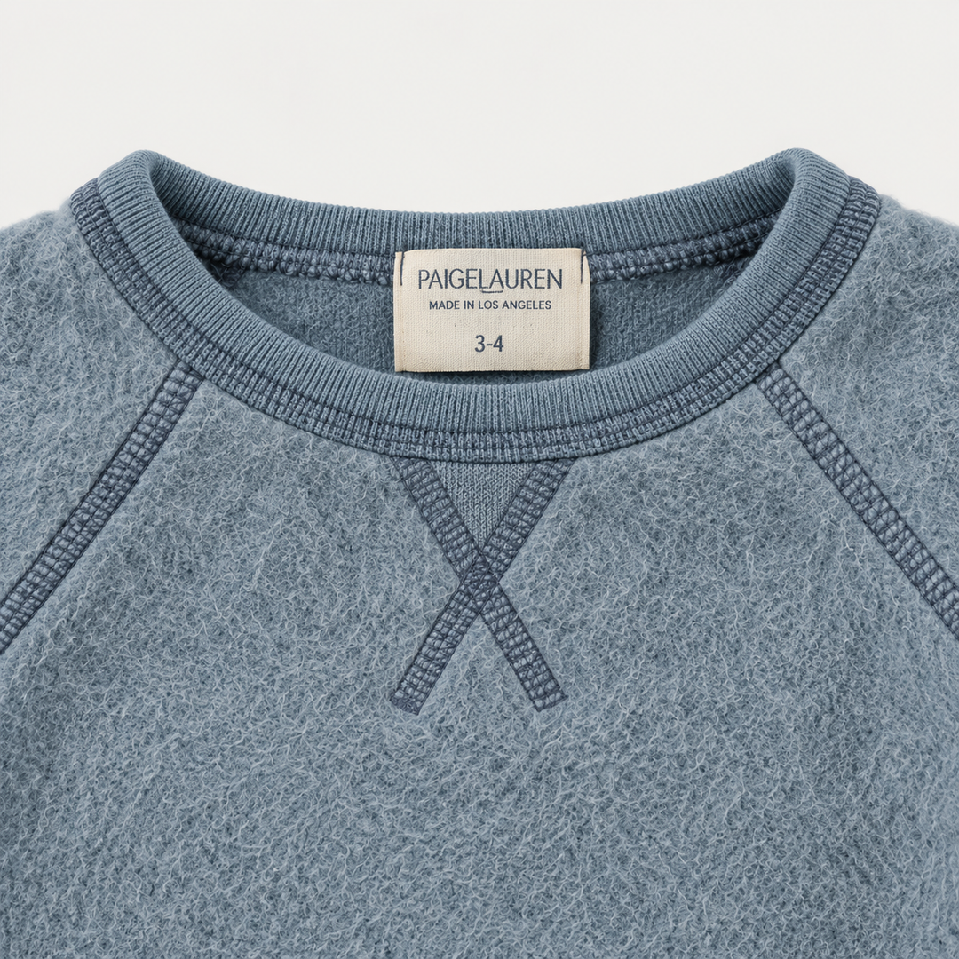 Blue brushed fleece boatneck sweatshirt with raglan seams and triangle neckline detail