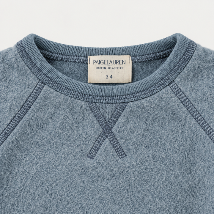 Blue brushed fleece boatneck sweatshirt with raglan seams and triangle neckline detail