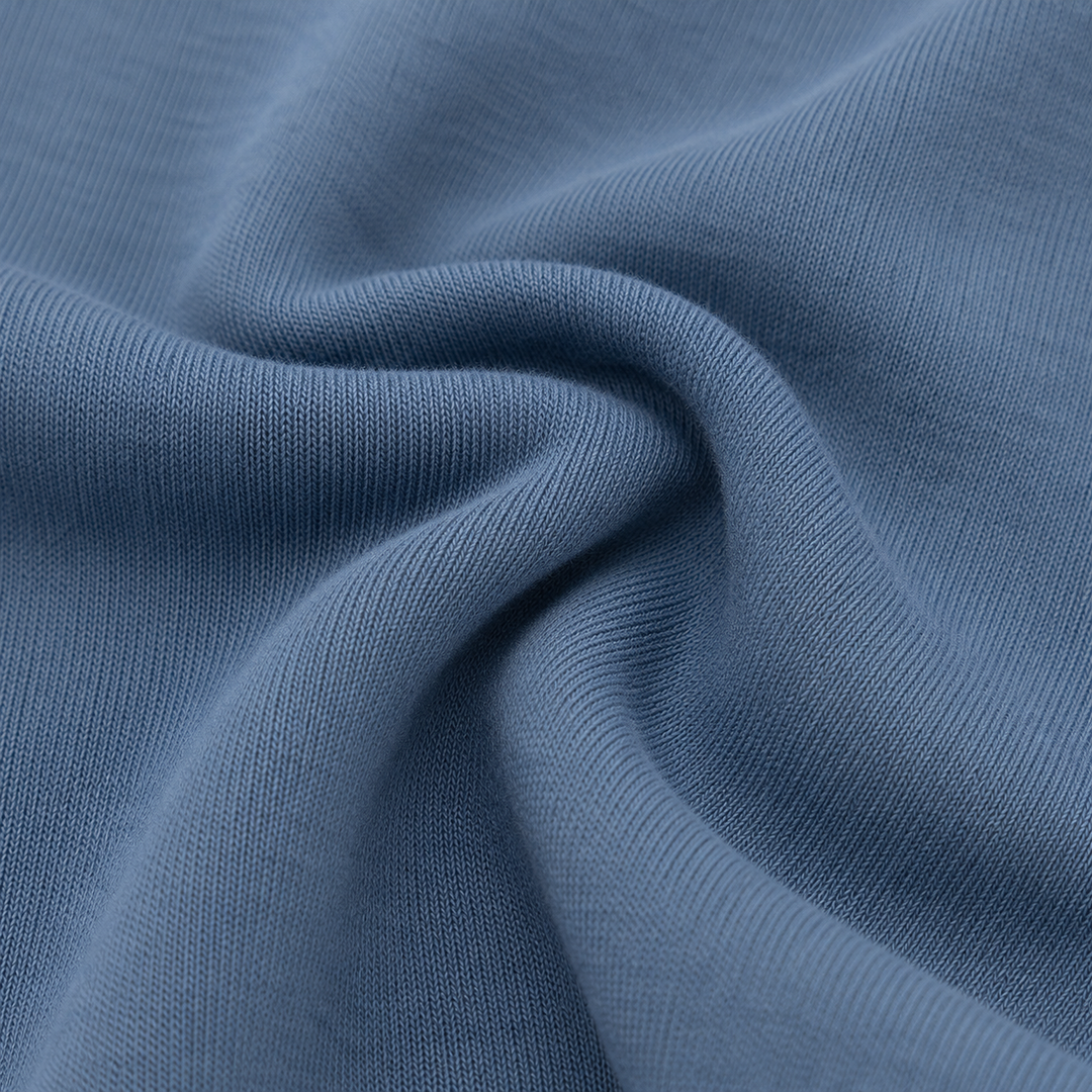 Close-up of soft PAIGELAUREN Blue Fleece fabric showing its cozy knit texture