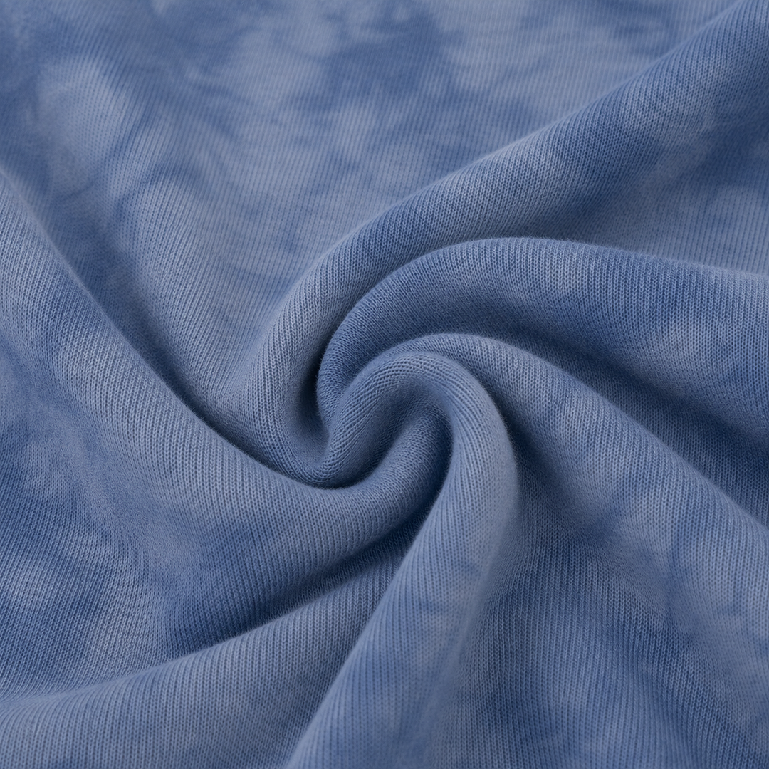 Close-up of soft fuzzy Blue Marble brushed hacci fabric and tonal marble dye