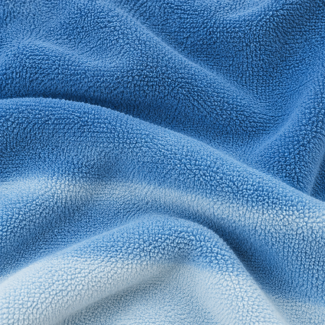 Close-up of soft blue ombré loop terry fabric showing plush textured loops