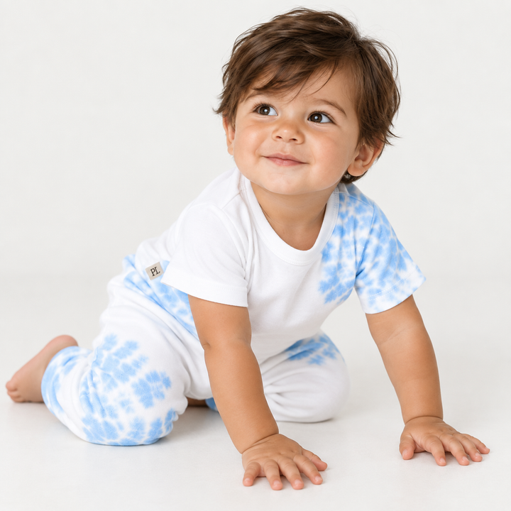 Baby boy crawling in PAIGELAUREN Blue and White Tie Dye Ribbed Tee and Legging Set