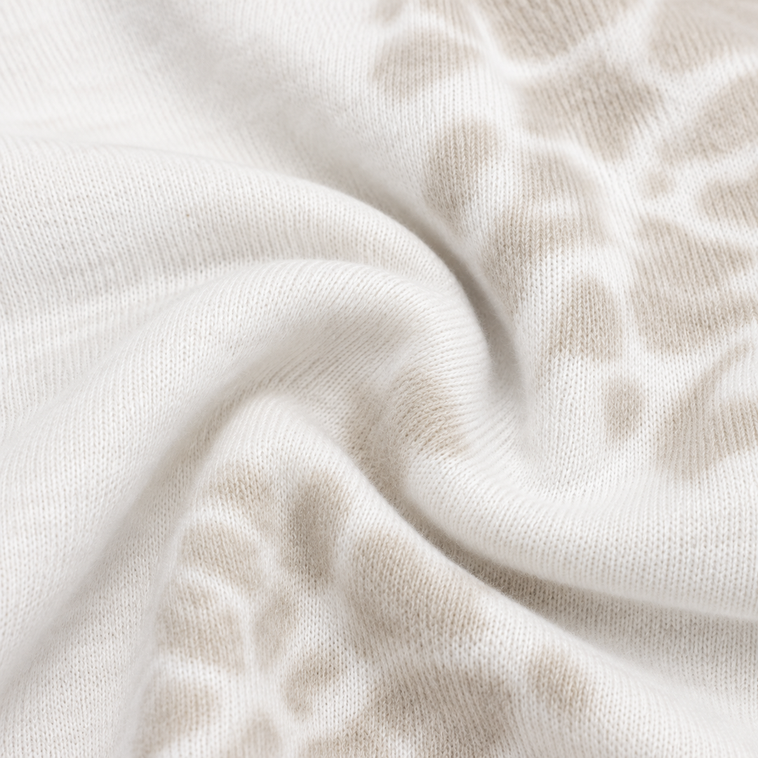 Close-up of PAIGELAUREN Bone and White tie dye ribbed fabric