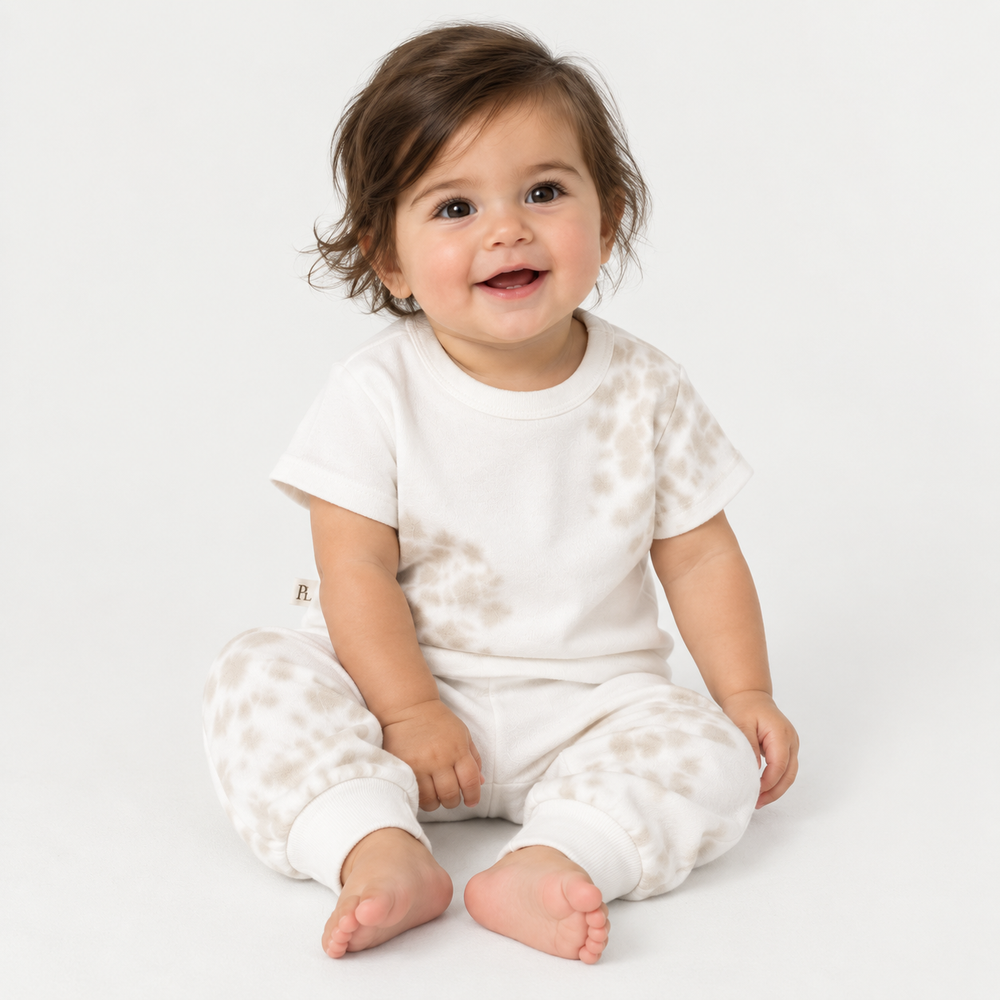 Baby wearing PAIGELAUREN Bone and White Tie Dye Ribbed Tee and Legging Set