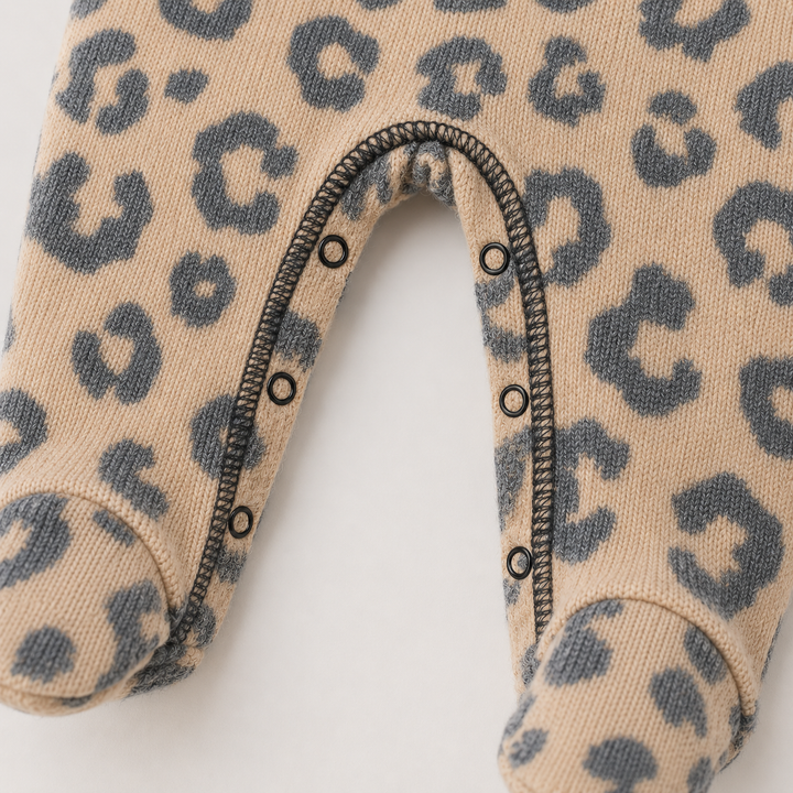 Inseam snap closure and built-in footie detail on Black and Taupe Brushed Hacci Animal Romper