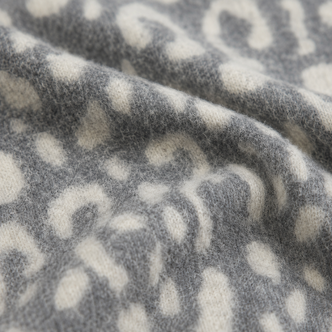 Close-up of soft fuzzy brushed hacci animal print fabric in Gray and Taupe
