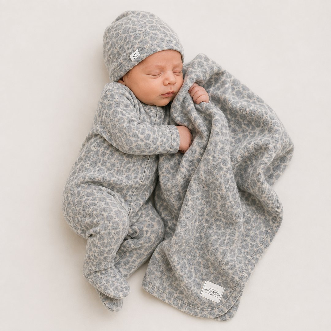 Newborn snuggling in PAIGELAUREN Gray and Taupe Brushed Hacci Animal Welcome Home Set
