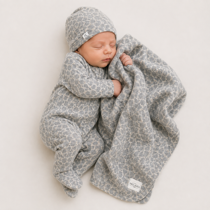 Newborn snuggling in PAIGELAUREN Gray and Taupe Brushed Hacci Animal Welcome Home Set