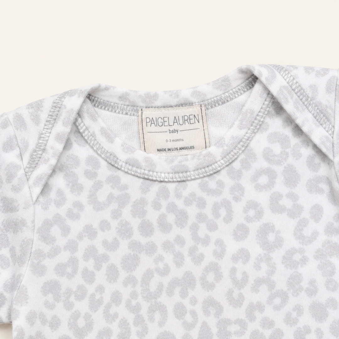 Lap shoulder neckline detail on PAIGELAUREN Gray and White Brushed Hacci Animal Footed Romper