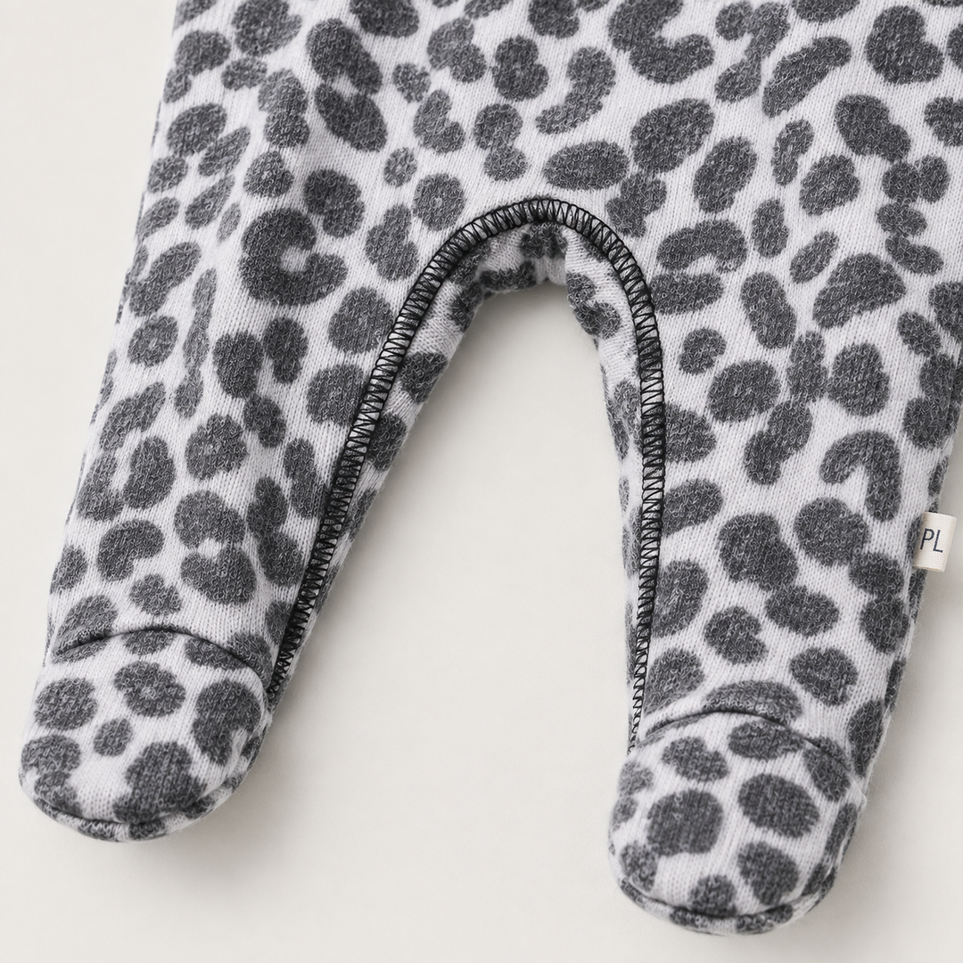 Crotch and footed leg detail of PAIGELAUREN black and white Brushed Hacci Animal Pajama