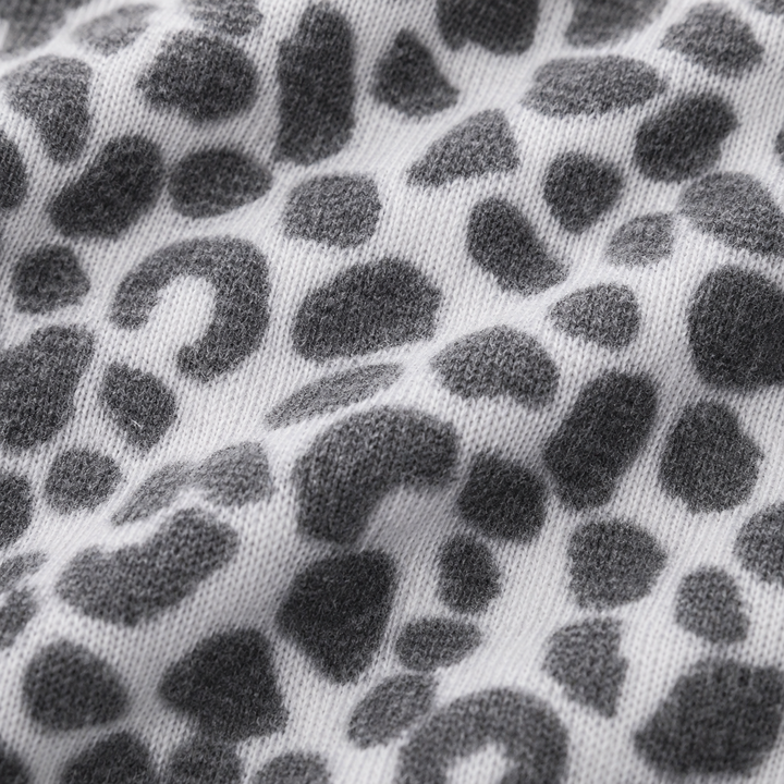 Close-up of ultra-soft black and white animal print brushed hacci fabric by PAIGELAUREN