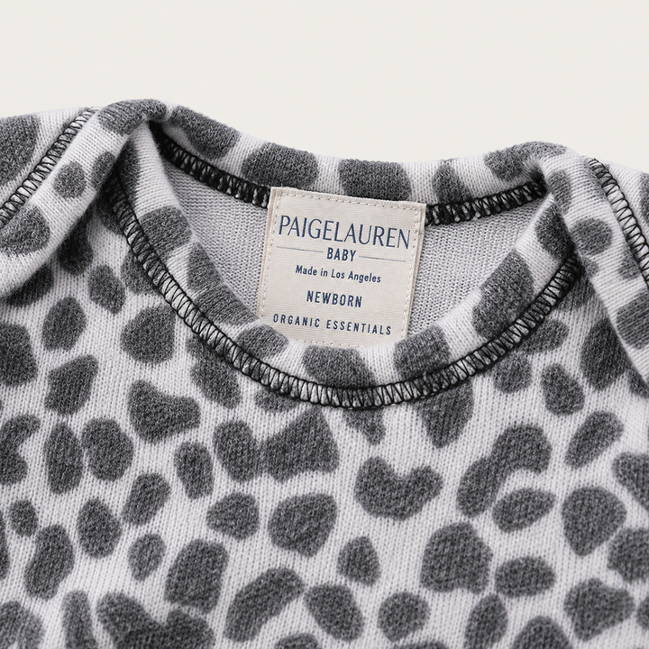 Neckline detail of PAIGELAUREN black and white Brushed Hacci Animal Pajama with lap shoulder and neck label