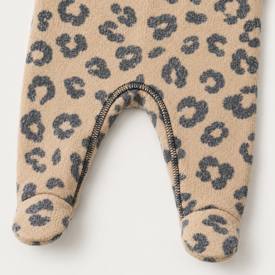 Close-up of crotch stitching and footed legs on the PAIGELAUREN camel Brushed Hacci Animal Pajama